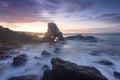 Sun setting behind the cave arch rock