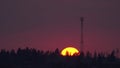 The sun setting behind cell tower Royalty Free Stock Photo