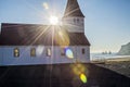 Sun setting behind church in Vik Iceland