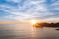 The sun setting behind Dubrovnik with a lively sky. Royalty Free Stock Photo