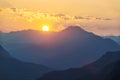 Sun setting behind mountains Royalty Free Stock Photo