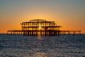 The sun setting behind the old West Pier in Brighton, on a winter\'s evening Royalty Free Stock Photo