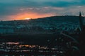 Sunset behind populated hill with reflection