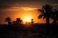 sun setting behind towering dunes, with silhouetted palm trees on the horizon Royalty Free Stock Photo