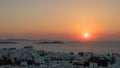 The sun setting behind the town of chora on the island of mykonos Royalty Free Stock Photo