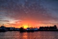 Sun setting between boats in Freo harbour Royalty Free Stock Photo