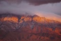 Sun setting on the cliffs of the Sandia mountains. Royalty Free Stock Photo