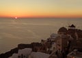 The sun setting on the horizon of Aegean sea, Oia village, Santorini island, Greece Royalty Free Stock Photo