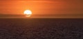 Sun is setting on horizon at sunset sunrise over sea or ocean Royalty Free Stock Photo