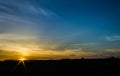 Sun setting over cow pasture