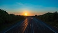 Sun setting over a empty motorway M40 with reduced traffic due to COVID-19