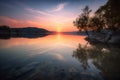 the sun is setting over a lake with trees in the foreground Royalty Free Stock Photo