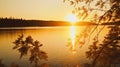 the sun is setting over a lake with trees in the foreground Royalty Free Stock Photo