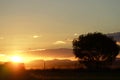 Sun setting over mountains as day ends rural country town Royalty Free Stock Photo