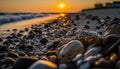 the sun is setting over the ocean and rocks on the shore of a beach with a wave coming in from the water and a few rocks on the Royalty Free Stock Photo