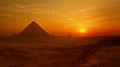 The sun is setting over the pyramids of Egypt Royalty Free Stock Photo