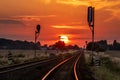 Sun is setting over the railroad tracks Royalty Free Stock Photo