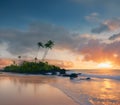 the sun setting over the shore of a small island near the ocean Royalty Free Stock Photo