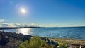 the sun is setting over the stone beach the reflections Pacific Ocean is very quiet and calm there are no waves relaxing Royalty Free Stock Photo