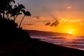 Sun setting over waves and palm trees on Sunset Beach, Hawaii Royalty Free Stock Photo