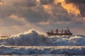 Sun setting at the sea with sailing cargo ship Royalty Free Stock Photo