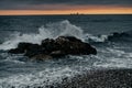 Sun setting at the sea with sailing cargo ship, scenic view Royalty Free Stock Photo