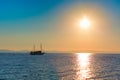 Sun setting at the sea with sailing ship Royalty Free Stock Photo