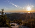 The sun setting and shining over the mountains and coast Royalty Free Stock Photo