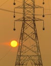 Sun setting beside the silhouette of pylon