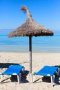 Sun shade and two sunbeds on the sand beach Royalty Free Stock Photo