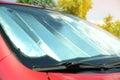 Sun shade under windshield in car, closeup. Heat protection