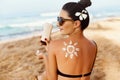 Sun shape created from sunscreen lotion on young woman`s back. Skin protection.Skin and Body Care.Facial  treatment. Sun Cream Sa Royalty Free Stock Photo
