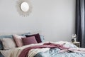 Sun shape like mirror on grey empty wall of comfortable bedroom interior Royalty Free Stock Photo