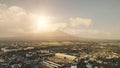 Sun shine over Mayon volcano erupt at Legazpi cityscape aerial. Philippines tourist landmark