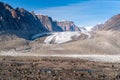 Sun shines above remote arctic valley of Akshayuk Pass, Baffin Island, Canada. Blue sky above Highway glacier. Arctic