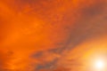 The sun shines against orange clouds is a dazzling natural phenomenon in the colorful combination of colors and shades of clouds. Royalty Free Stock Photo