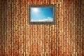 sun shines on blue sky with clouds in wooden frame on brick wall Royalty Free Stock Photo