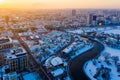 Sun shines bright above Minsk city on cold winter day, aerial landscape. River gets frozen