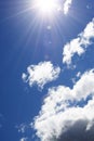 The sun shines brightly against the sky. Blue sky with white clouds Royalty Free Stock Photo