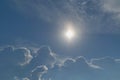 The sun shines brightly in the clear blue sky. Big storm clouds are coming. Royalty Free Stock Photo