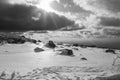 The sun shines through the clouds in a snowy mountain range. winter landscape, Serra da Estrela