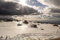 The sun shines through the clouds in a snowy mountain range. winter landscape, Serra da Estrela