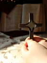 The Sun shines on a cross in man`s hands when he prays. Royalty Free Stock Photo