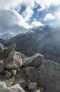 The sun beats down over the peak to some stones