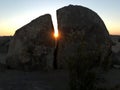 The sun shines through a hole in the rock. Desert Mojave. California