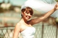Sun shines over a beautiful bride posing on the roof