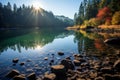 the sun shines over a lake surrounded by trees and rocks