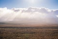 Sun shines over low clouds above vast and empty land along Volcanic Loop Hwy and Desert Road. Central Plateau, New