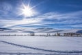 Sun shines over snowy field. Royalty Free Stock Photo