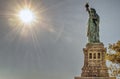 The sun shines on the statue of Liberty in New York. Royalty Free Stock Photo